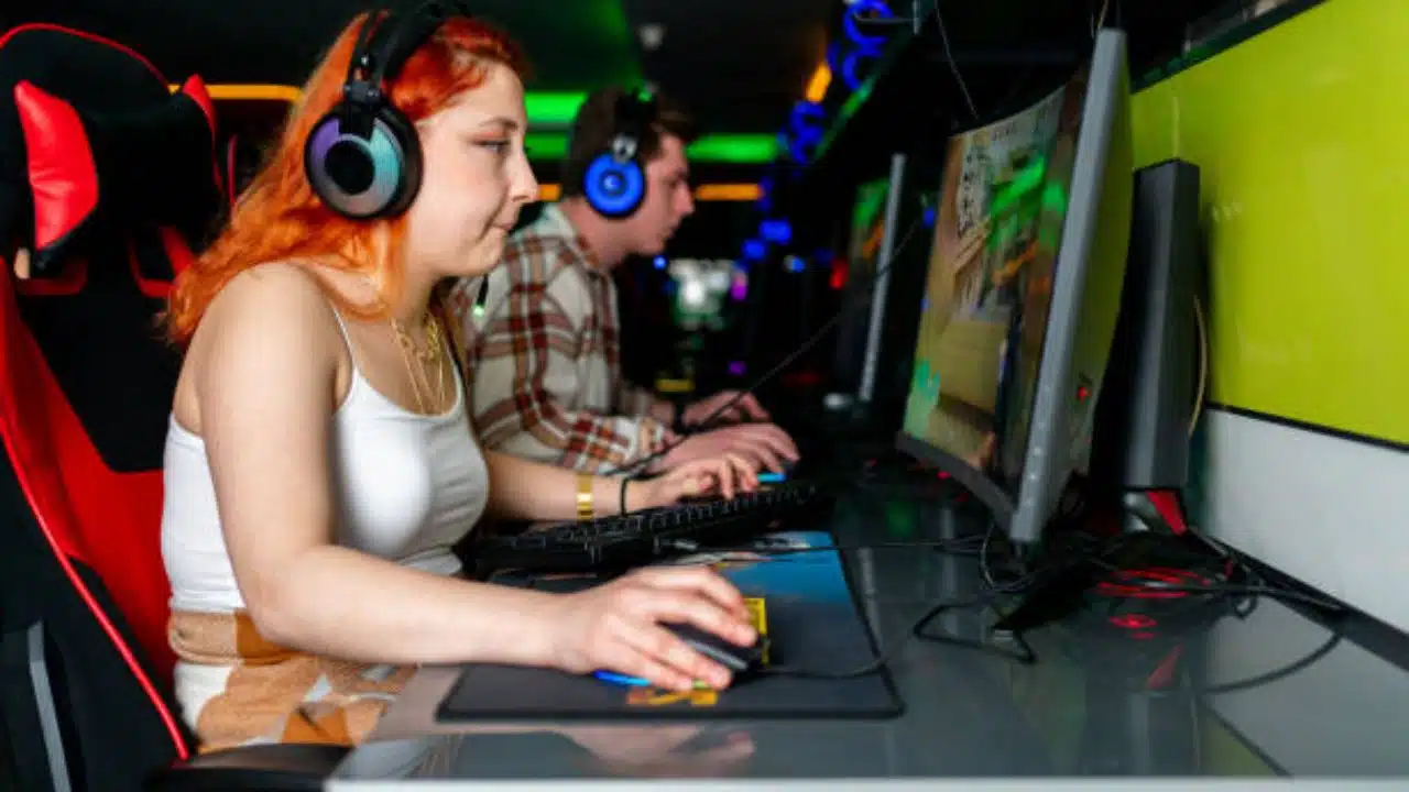 Woman Smiling while Playing Computer online Game