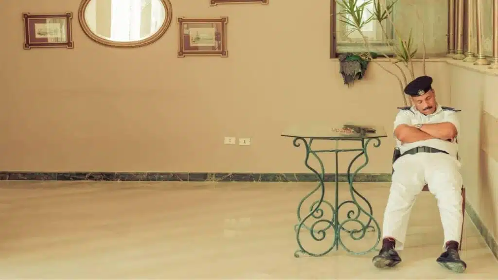 sleeping egyptian guard on chair at hotel entrance area