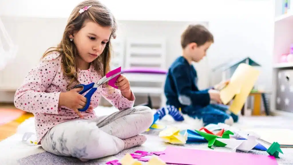 Kids making origami crafts with paper