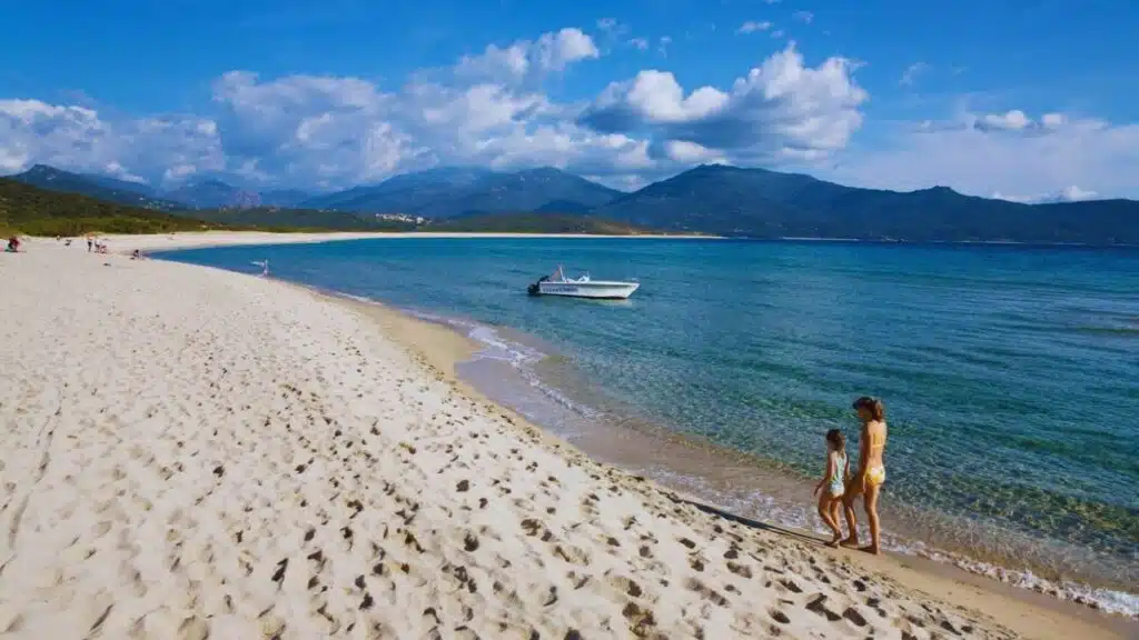 Mother and daughter walking along Portigliolo beach near Propriano, Golfe de Valinco, Corsica, France, Europe