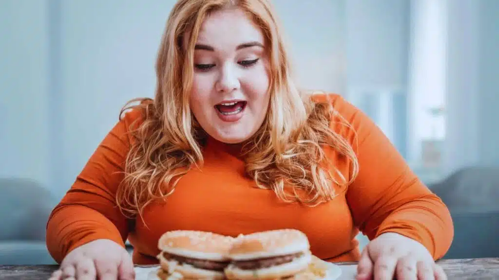 Pretty plump girl dreaming about fat burger