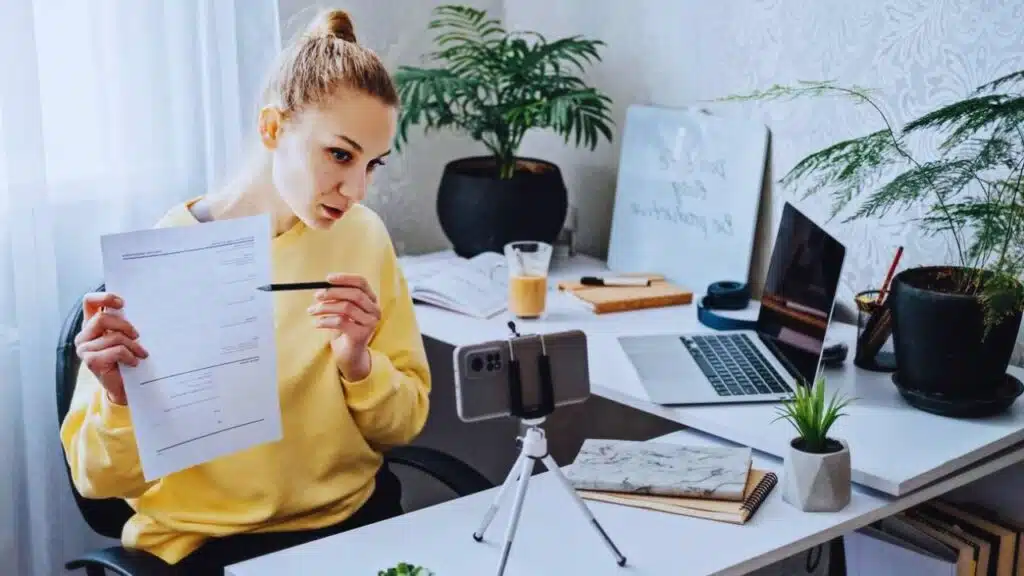 Online Side Hustle Ideas To Make Money Fast. Young woman speaking in front of camera for vlog as consultant, blogger, recording video tutorial