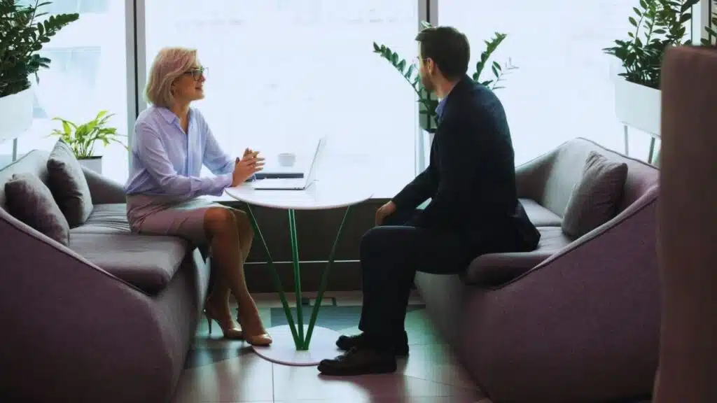 Smiling older hr manager holding job interview in office