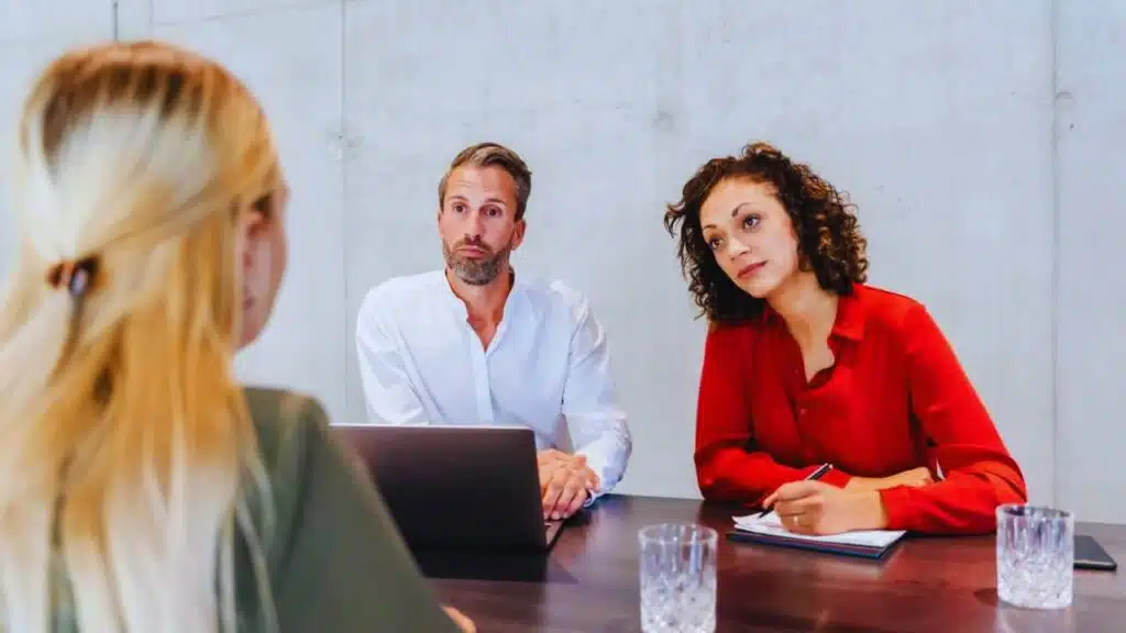 Businesswoman taking job interview of candidate in board room