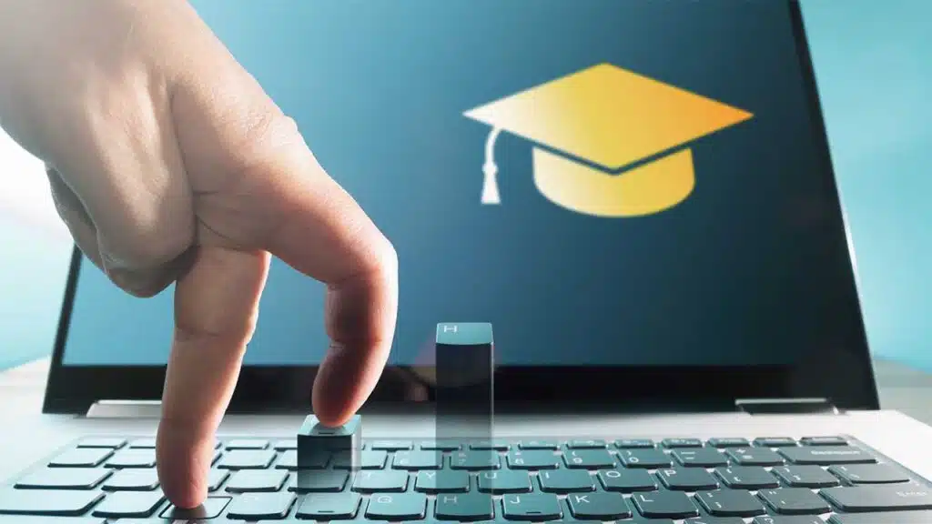 Online learning concept with graduation cap on laptop screen