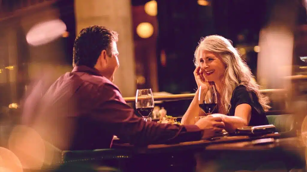 A couple enjoying a romantic dinner with wine