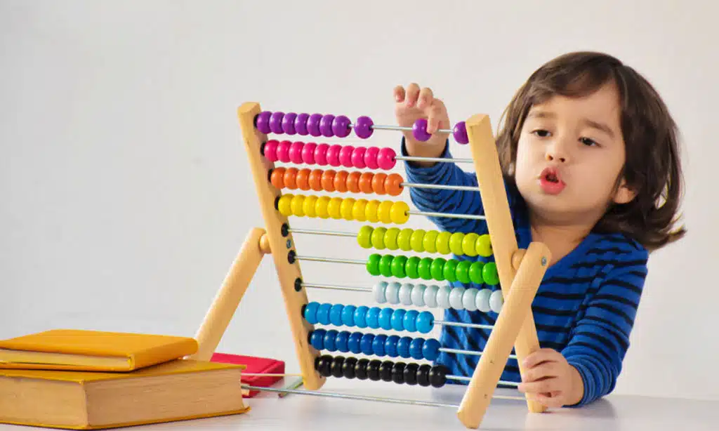 Child playing with a colorful abacus.