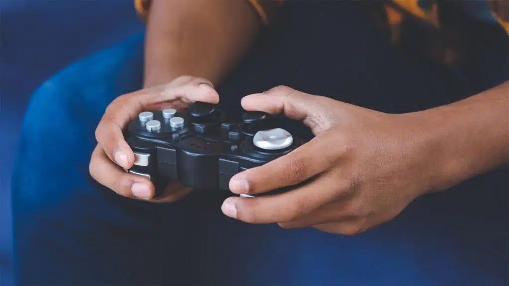 Close-up of hands holding a video game controller.