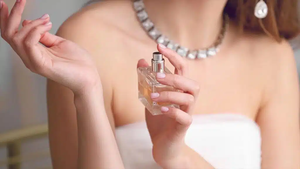Woman applying perfume on her wrist