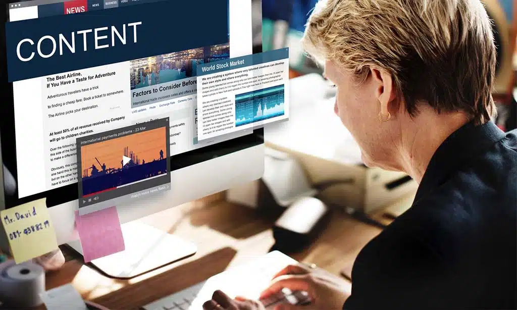 Person working on content creation with digital tools on a computer.