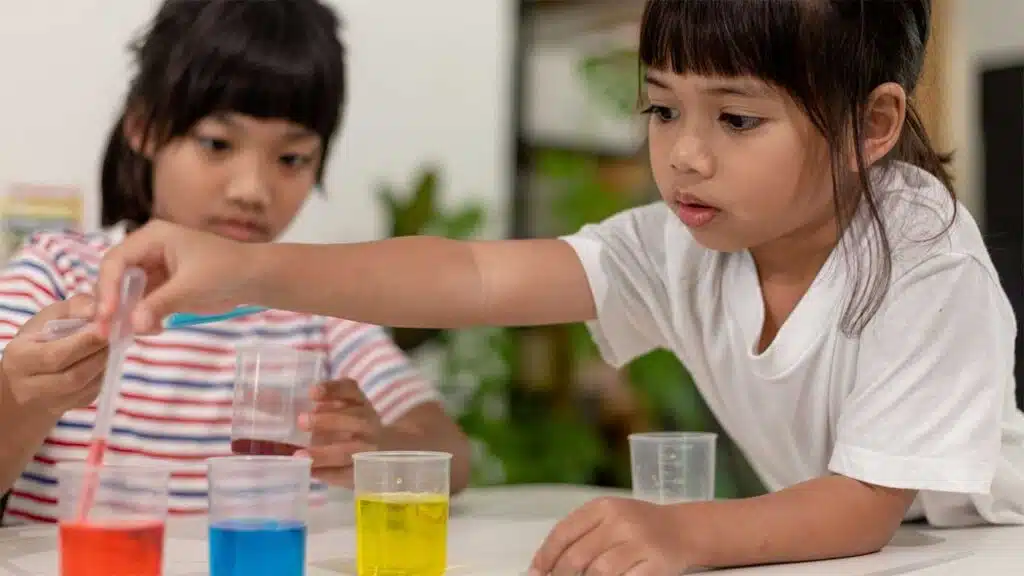 Children conducting a color mixing experiment.