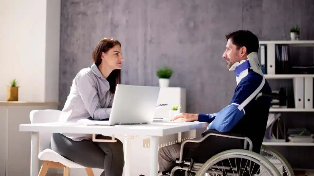 A lawyer consulting with a client who is in a wheelchair