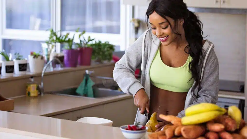 Woman preparing a healthy meal in the kitchen.