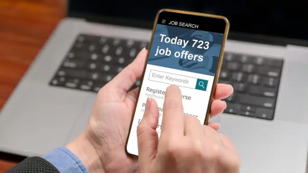 Person using a mobile job search app on a smartphone to find job offers