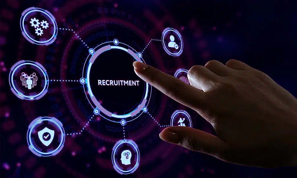 Finger touching a digital "Recruitment" button on a futuristic interface.