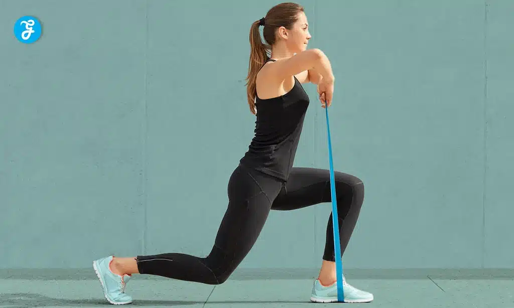 Woman exercising with a resistance band, doing lunges