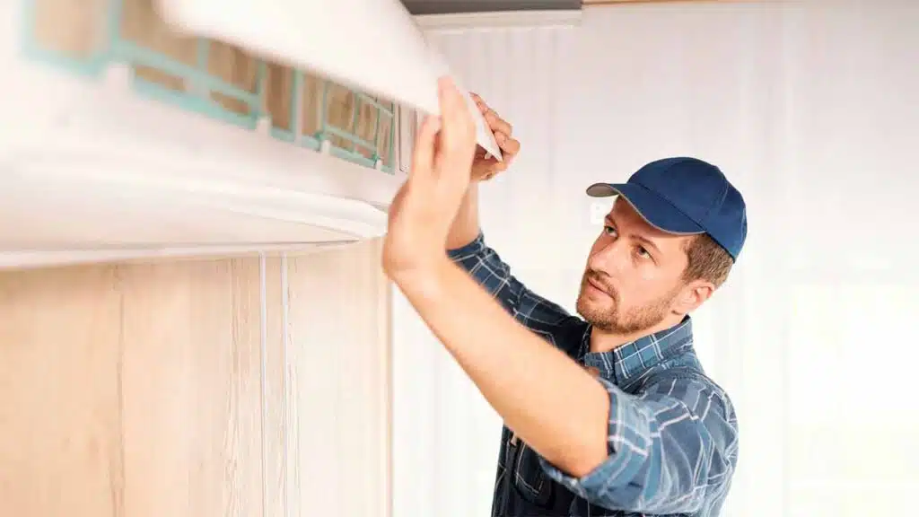 Technician performing air conditioning maintenance