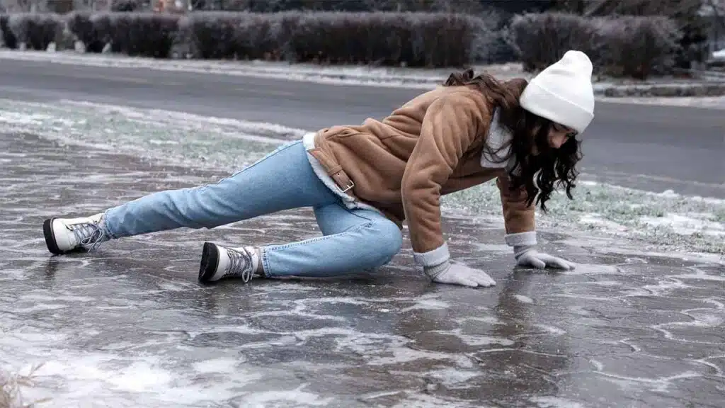 Person slipping on icy sidewalk,