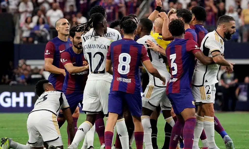 Intense moment during a football match between players wearing the kits of two famous football clubs