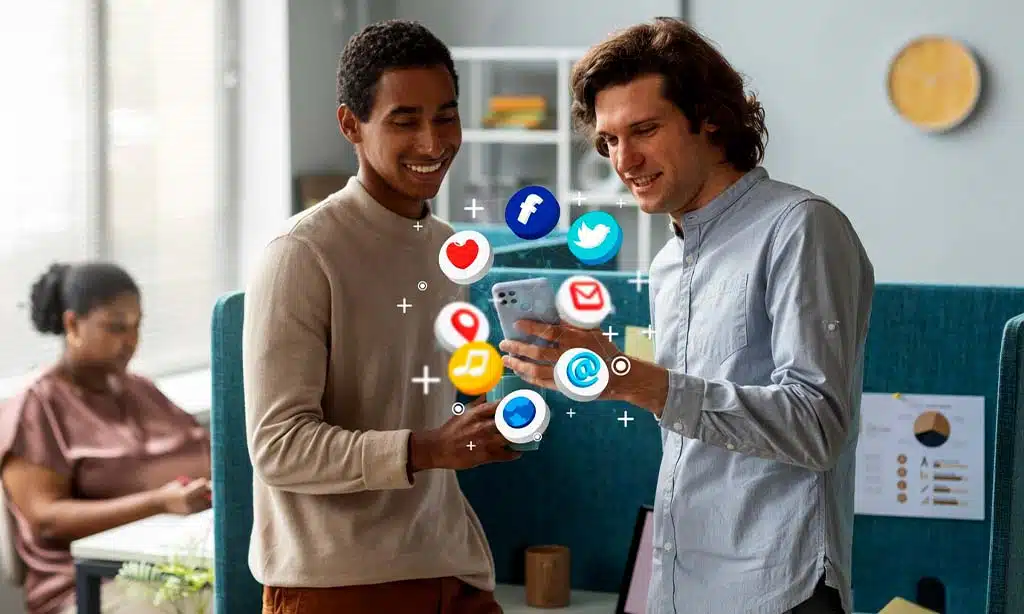 Two colleagues discussing social media on a smartphone