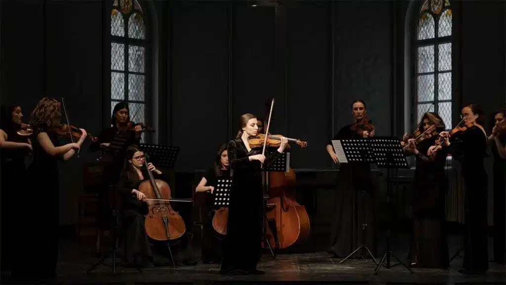 Orchestra performing a classical music concert on stage.