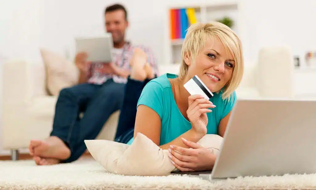 Woman shopping online with a credit card