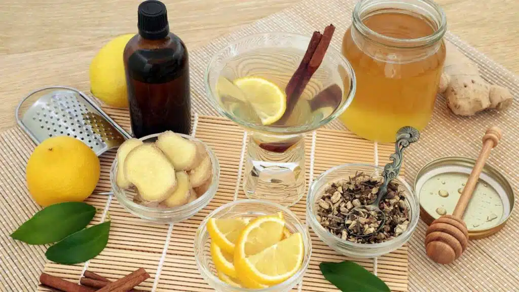 Natural remedy ingredients: ginger, lemon, honey, and herbs.