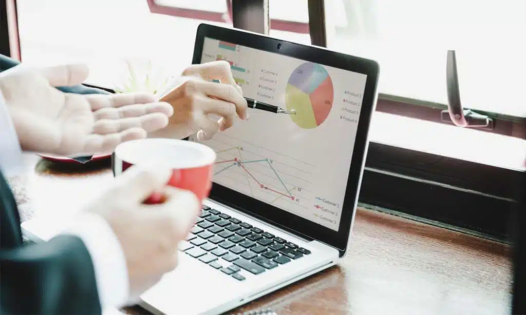 Discussing data analytics and business growth on a laptop.