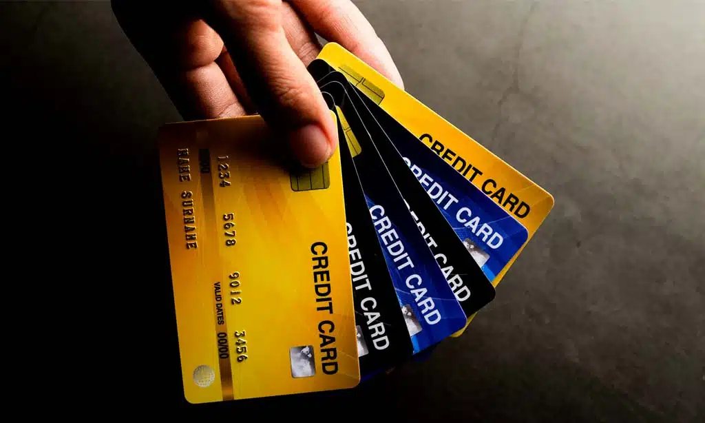 Hand holding multiple credit cards, representing financial management