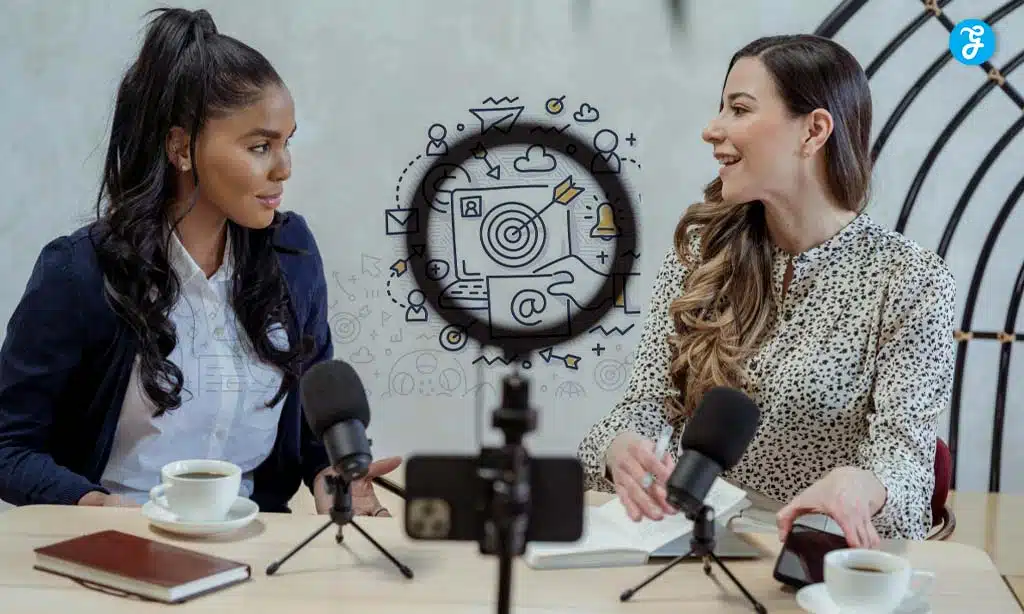 Two women recording a podcast in a modern studio setting.