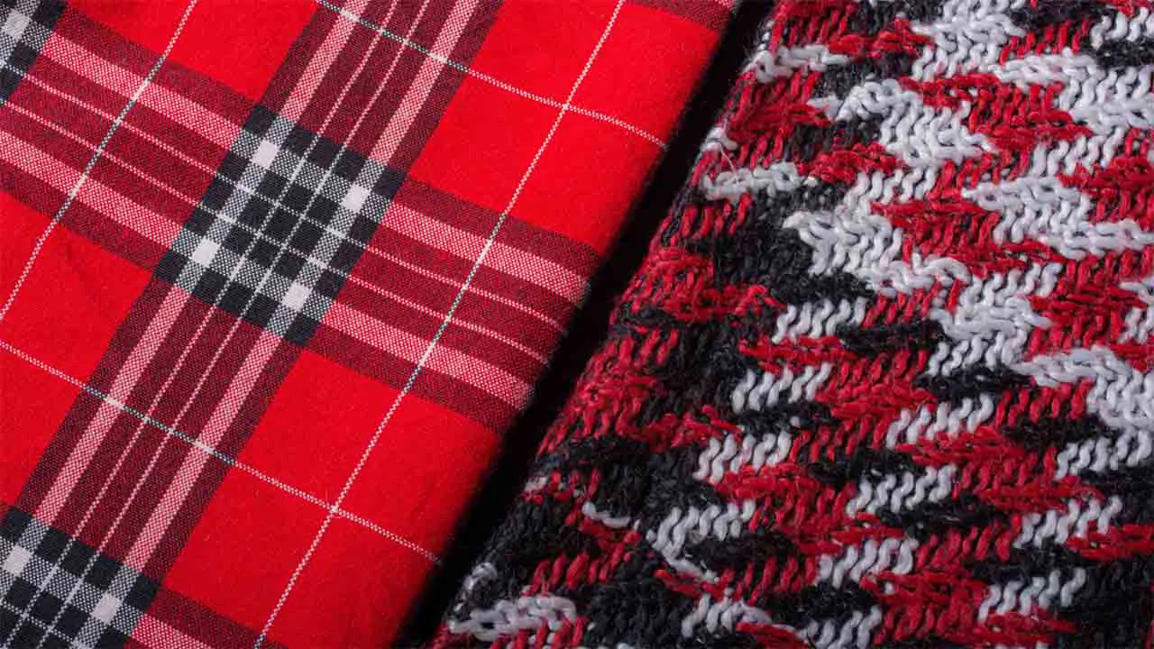 Close-up of red plaid and knitted fabric textures.