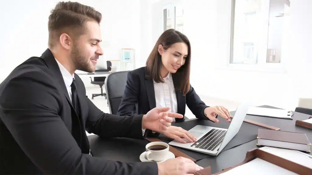 Two business professionals collaborate in a modern office