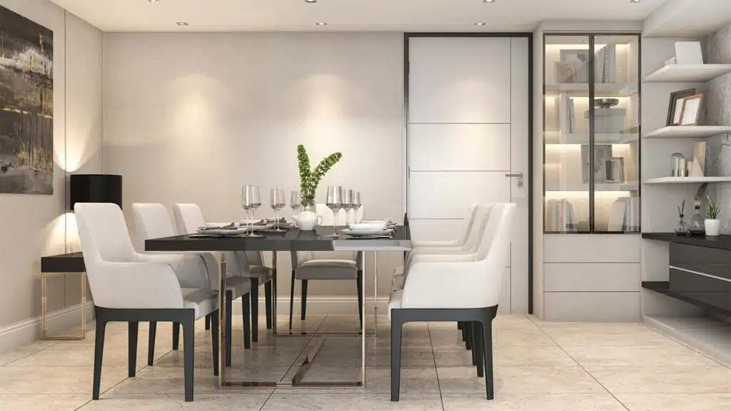 Elegant dining room with a sleek black table, white cushioned chairs, and modern decor.