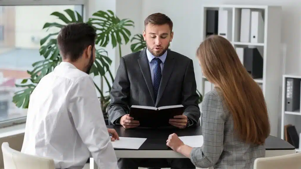 Lawyer meeting with a couple in a modern office, discussing legal documents