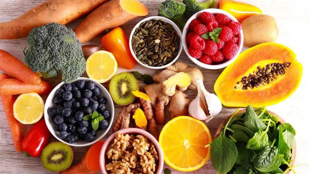 Assortment of fresh fruits, vegetables, nuts, and seeds, showcasing a healthy diet