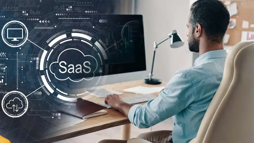 Man working at a desk with SaaS (Software as a Service)