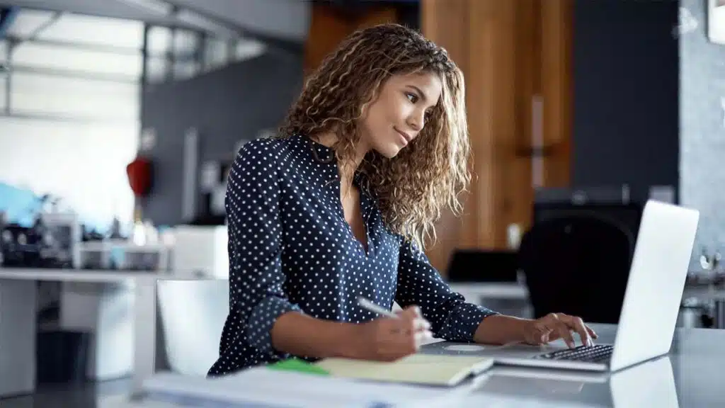 Young Professional Woman Working on Laptop in Modern Office