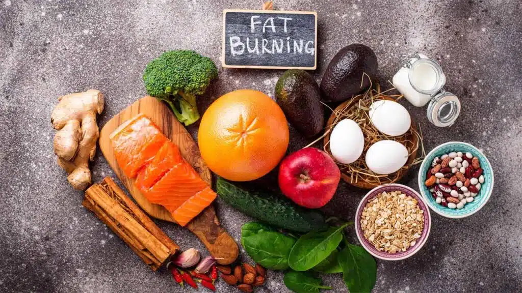 Fat-burning foods including salmon, grapefruit, avocado, eggs, and nuts.