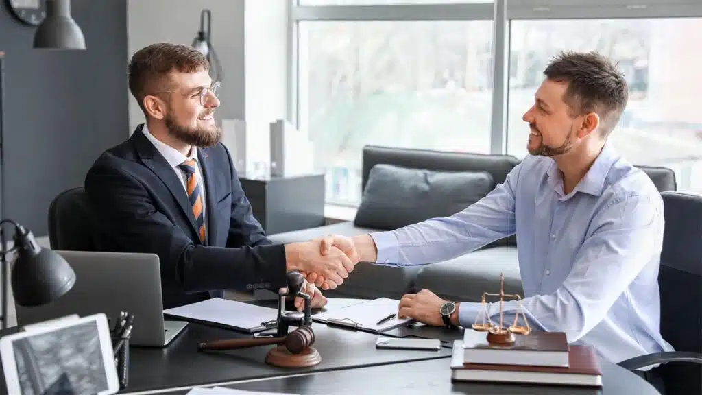 Businessmen shaking hands in a modern office, sealing a partnership or agreement with legal documents