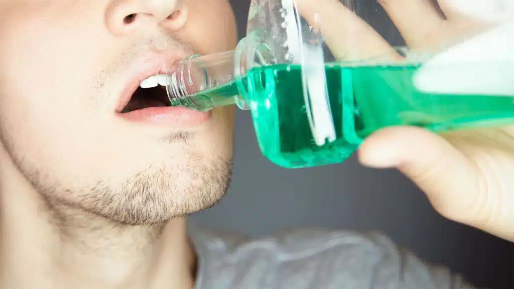 Man using mouthwash for oral hygiene