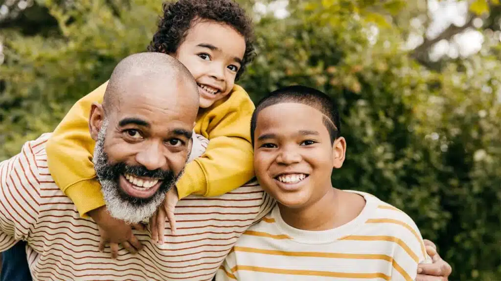 Happy father and his two sons enjoying time together outdoors