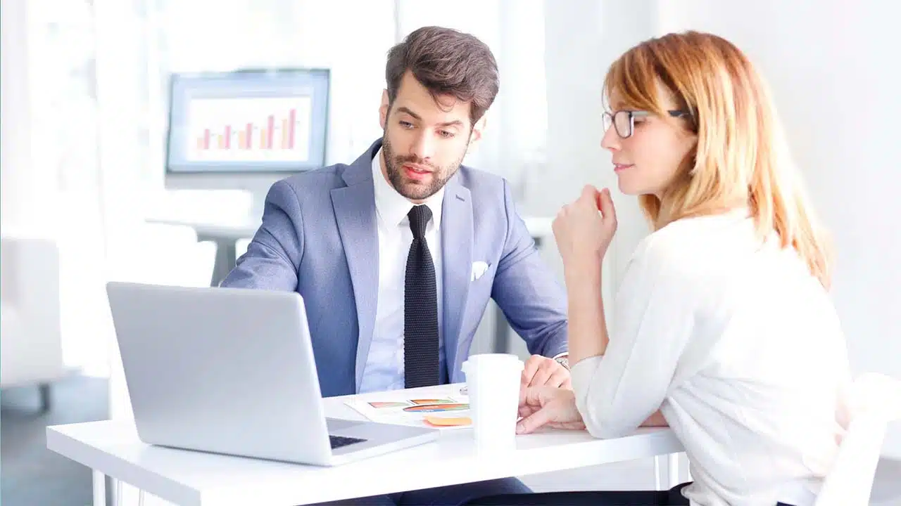 A woman asking a question to a man about banking