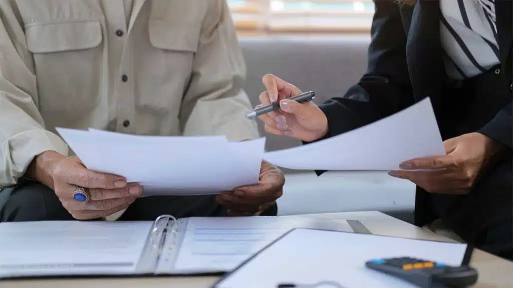 Two individuals engaged in reviewing documents