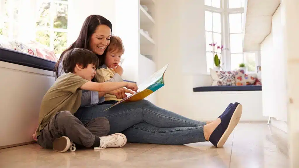 The family appears happy and absorbed in the shared activity of reading together
