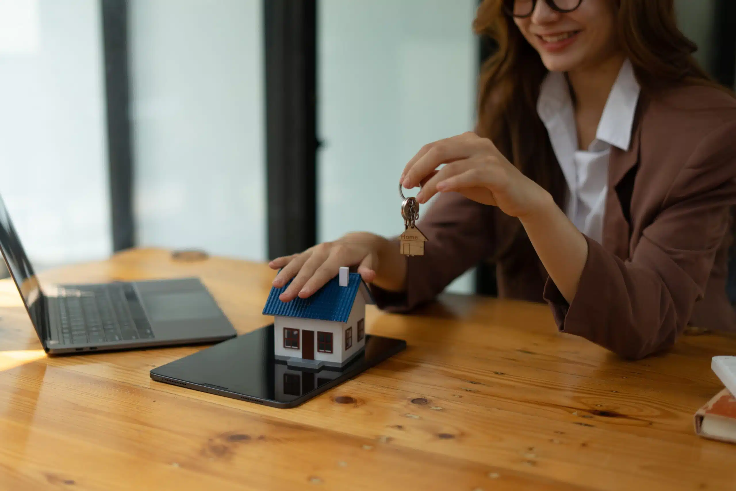 Woman,Holding,White,House,Model,And,House,Key,In,Hand.mortgage