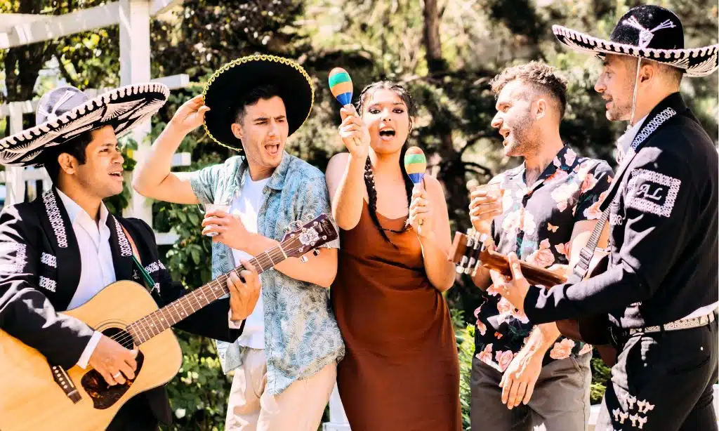 A Group of People Dancing to Mexican Music Wearing Latin Hats