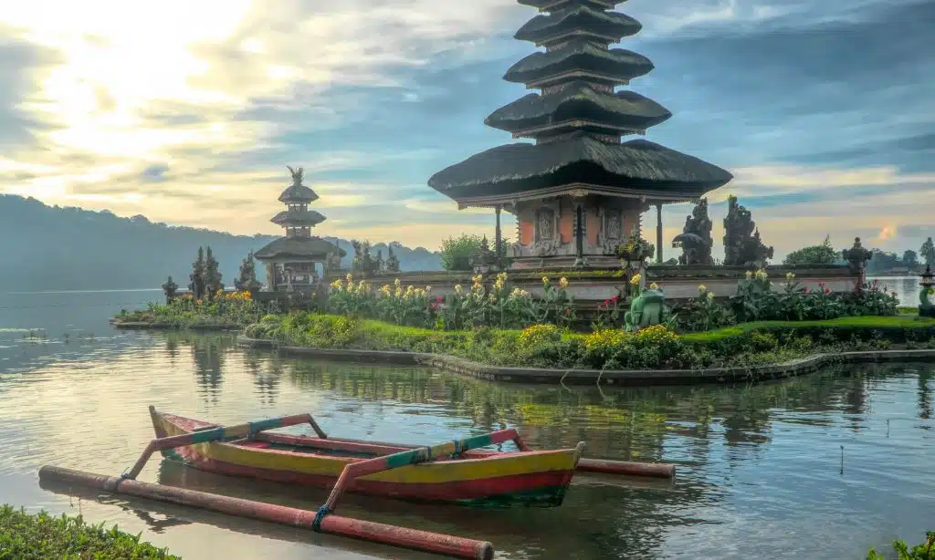 Canoe on Body of Water With Pagoda in Bali, Indonesia